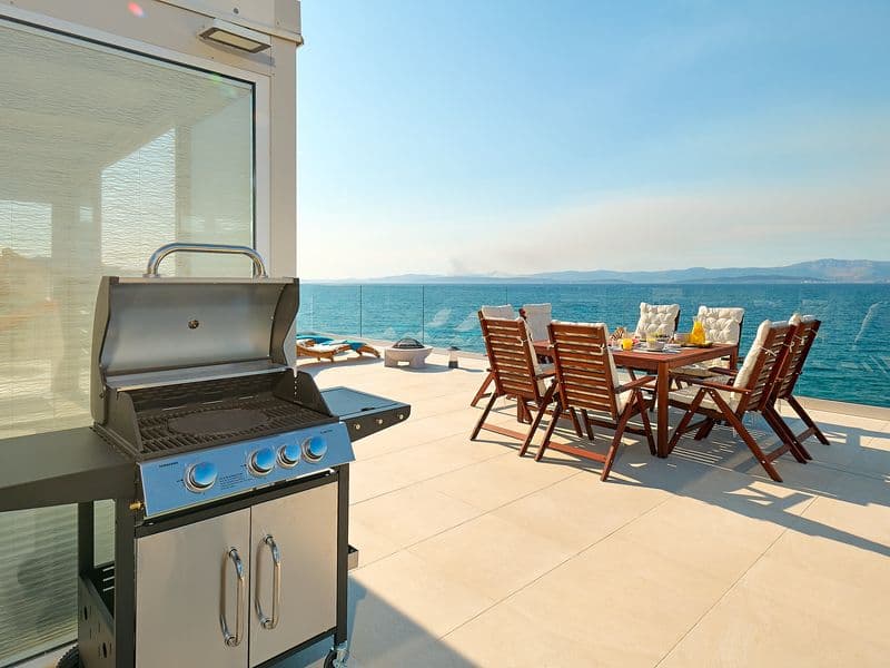 Rooftop beachfront dining area with spectacular sea view, modern gas grill, Dalmatia holiday rental